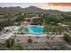 Aerial view of community pool and clubhouse at sunset at 11157 E Greenway Rd, Scottsdale, AZ 85255