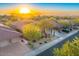 Aerial sunset view of a luxury home and neighborhood at 11157 E Greenway Rd, Scottsdale, AZ 85255