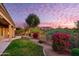 Landscaped backyard with a grassy area and flowering bushes, and a mountain view at 11157 E Greenway Rd, Scottsdale, AZ 85255