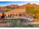 Home with large covered patio, grassy area, and mountain views at 11157 E Greenway Rd, Scottsdale, AZ 85255
