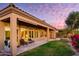 Spacious backyard patio with seating, overlooking a beautifully landscaped yard at 11157 E Greenway Rd, Scottsdale, AZ 85255