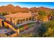 Desert landscape with a covered patio, grassy area, and mountain views at 11157 E Greenway Rd, Scottsdale, AZ 85255