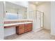 Bathroom with shower, dual vanity, and large mirror at 11157 E Greenway Rd, Scottsdale, AZ 85255