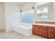 Bathroom with soaking tub, shower, and dual vanity at 11157 E Greenway Rd, Scottsdale, AZ 85255