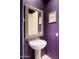 Bathroom with pedestal sink and purple walls at 11157 E Greenway Rd, Scottsdale, AZ 85255