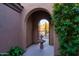 Courtyard with fountain and mountain view through archway at 11157 E Greenway Rd, Scottsdale, AZ 85255