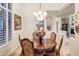Formal dining room with hardwood floors, chandelier, and seating for four at 11157 E Greenway Rd, Scottsdale, AZ 85255