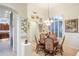 Elegant dining room with hardwood floors, chandelier, and beautiful artwork at 11157 E Greenway Rd, Scottsdale, AZ 85255