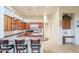 Modern kitchen with breakfast bar, stainless steel appliances, and custom cabinetry at 11157 E Greenway Rd, Scottsdale, AZ 85255