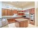 Gourmet kitchen featuring granite island, stainless steel appliances, and rich wood cabinets at 11157 E Greenway Rd, Scottsdale, AZ 85255