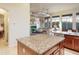 Kitchen island with granite countertop and view into living room and dining area at 11157 E Greenway Rd, Scottsdale, AZ 85255