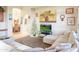 Living room with sectional sofa, large TV, and view to dining area at 11157 E Greenway Rd, Scottsdale, AZ 85255