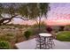 Patio with seating area offering scenic sunset views and mountain backdrop at 11157 E Greenway Rd, Scottsdale, AZ 85255