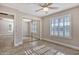 Spacious bedroom with mirrored closet doors and ceiling fan at 13624 W Aleppo Dr, Sun City West, AZ 85375