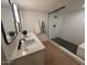 Updated bathroom with double vanity and walk-in shower at 1745 E Glade Ave, Mesa, AZ 85204