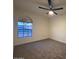Bright bedroom with arched window and ceiling fan at 1745 E Glade Ave, Mesa, AZ 85204