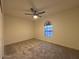 Bright bedroom with arched window and ceiling fan at 1745 E Glade Ave, Mesa, AZ 85204