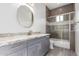 Modern bathroom with grey vanity, a shower/tub combo, and flooring at 2917 N Katie Ln, Litchfield Park, AZ 85340