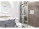 Modern bathroom with gray tile shower and granite vanity at 2917 N Katie Ln, Litchfield Park, AZ 85340