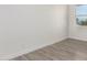Spacious bedroom with gray wood-look floors and a window at 2917 N Katie Ln, Litchfield Park, AZ 85340