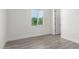 Simple bedroom with grey flooring and a window at 2917 N Katie Ln, Litchfield Park, AZ 85340