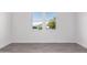 Well-lit bedroom with grey flooring and large window at 2917 N Katie Ln, Litchfield Park, AZ 85340