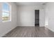 Light and airy bedroom with grey flooring and a window at 2917 N Katie Ln, Litchfield Park, AZ 85340