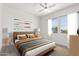 Bright bedroom with wood-look floors and a cozy bed at 2917 N Katie Ln, Litchfield Park, AZ 85340