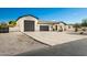 New construction home with a modern design, featuring a large driveway and three-car garage at 2917 N Katie Ln, Litchfield Park, AZ 85340