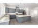 Modern kitchen with gray cabinets, granite countertops, and island at 2917 N Katie Ln, Litchfield Park, AZ 85340