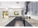 Modern kitchen with gray cabinets and granite countertops at 2917 N Katie Ln, Litchfield Park, AZ 85340
