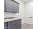 Laundry room with gray cabinets and granite countertops at 2917 N Katie Ln, Litchfield Park, AZ 85340