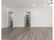 Open living area with gray wood-look floors at 2917 N Katie Ln, Litchfield Park, AZ 85340