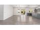 Open living room with gray wood-look floors and sliding doors to patio at 2917 N Katie Ln, Litchfield Park, AZ 85340