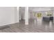 Open living room with gray wood-look floors, and views into the kitchen at 2917 N Katie Ln, Litchfield Park, AZ 85340