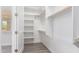 Spacious walk-in closet with built-in shelves and hanging rods at 2917 N Katie Ln, Litchfield Park, AZ 85340