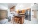 Kitchen boasts granite countertops and breakfast bar with two stools at 3433 W Mescal St, Phoenix, AZ 85029
