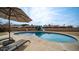 Inviting kidney-shaped pool with patio furniture and umbrella at 3433 W Mescal St, Phoenix, AZ 85029