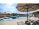 Refreshing pool with lounge chairs and patio umbrella at 3433 W Mescal St, Phoenix, AZ 85029