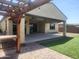 A covered patio and green turf create an inviting outdoor space at 4866 N 185Th Dr, Goodyear, AZ 85395