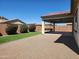 A private backyard oasis with low-maintenance gravel, artificial turf, mature landscaping, and covered patio for outdoor entertaining at 4866 N 185Th Dr, Goodyear, AZ 85395