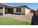 A well-maintained backyard featuring low-maintenance desert landscaping, artificial turf, and a covered patio area at 4866 N 185Th Dr, Goodyear, AZ 85395