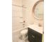 Bathroom featuring tub/shower combination, vanity with dark cabinets, and decorative mirror at 4866 N 185Th Dr, Goodyear, AZ 85395