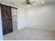 Large bedroom with a modern barn door, neutral carpet, and ample natural light at 4866 N 185Th Dr, Goodyear, AZ 85395