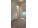 A cozy bedroom with plush carpeting, a window, and a neutral color scheme at 4866 N 185Th Dr, Goodyear, AZ 85395