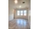 Bright bedroom with tile flooring, tray ceiling, and large windows allowing ample natural light at 4866 N 185Th Dr, Goodyear, AZ 85395