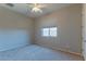 Well-lit bedroom featuring neutral walls and carpet at 4866 N 185Th Dr, Goodyear, AZ 85395