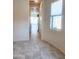Bright hallway with neutral walls and tile flooring leading to other rooms at 4866 N 185Th Dr, Goodyear, AZ 85395