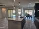 Open concept kitchen has a large island, granite countertops, modern appliances, and ample cabinet space at 4866 N 185Th Dr, Goodyear, AZ 85395