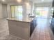 Spacious kitchen island with granite countertop and sink, overlooking the bright and open living space at 4866 N 185Th Dr, Goodyear, AZ 85395